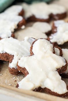 some cookies with white icing on top of a table