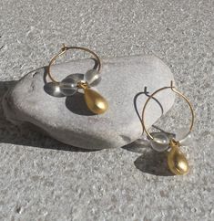 Handcrafted, sweet little gold tone metal hoops are beaded with lightweight clear plastic beads and gold tone metal teardrops.     They measure approximately 3/4" (1.9 cm) wide and 1 1/4" (3.2 cm) long from top of earring wire to bottom of teardrop. Earrings will come in a drawstring gift pouch and carefully placed in a bubble mailer.  Ships from a Smoke-Free environment, First Class USPS (includes domestic tracking #). Thank you for visiting www.etsy.com/shop/thefoxandfilly  -  Please favorite Gold Teardrop Hoop Earrings With Dangling Beads, Gold Pearl Drop Hoop Earrings, Gold Teardrop Earrings With Dangling Beads, Gold Teardrop Earrings With Gold Beads, Gold Brass Hoop Earrings With Dangling Beads, Earring Wire, Plastic Beads, Jewelry Earrings Hoops, Gold Tone Metal