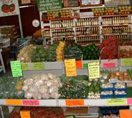 an assortment of fruits and vegetables on display in a grocery store