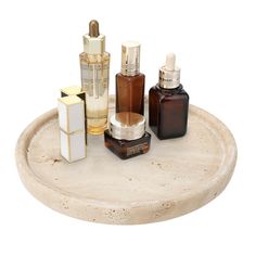 an assortment of skin care products displayed on a marble tray against a white background with copy space