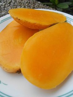 two pieces of fruit sitting on top of a white plate