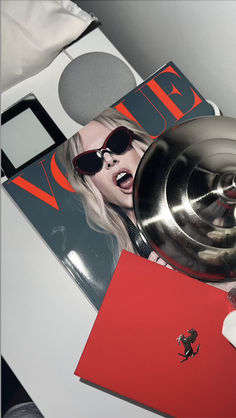 a magazine with sunglasses on top of it