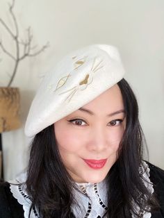 Stunning french chic off white wool beret with super cute gold cat eyes and whiskers embroidery, so adorable! FREE SHIPPING IN UKOne size fit 56cm-58cm head circumference. Also available in black. READY TO SHIP AND TO WEAR. For special colours Please send email request via info@yuanli.londonPlease note, we try our best to describe and photography the product, but the colour on screen can be slightly different in real life due to monitor and light. THIS LISTING IS ONLY FOR HAT, CLOTHING AND ACCES White Winter Beret Cap, White Winter Beret, Cats Eyes, Cat Embroidery, Summer Straw Hat, Lilac Roses, Wool Beret, Moustaches, Wool Berets