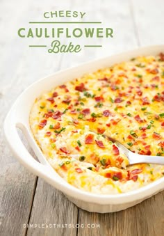 cheesy cauliflower bake in a white casserole dish with a serving spoon