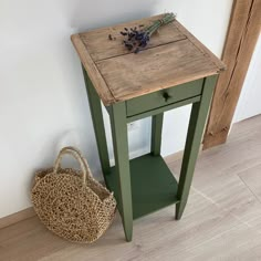 a small wooden table with a basket next to it