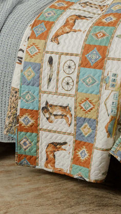 a bed with a dog quilt on top of it