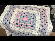 a crocheted blanket sitting on top of a table