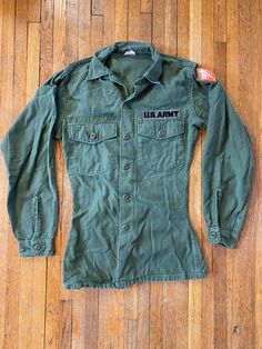 "70's OG-107 Fatigue Button Up Shirt- Vietnam War(Army Green) Great vintage condition. Clean, only signs of wear are name tag being removed, repaired stitching under armpits and on left pocket. Slight fraying on hems. Tag size listed 15.5X33 . Please review measurements as some vintage items fit smaller than modern sizing. Measurements taken with garment laid flat: 21\" across from armpit to armpit 28\" length from shoulder to hem 23\" sleeve from shoulder to hem Please send a message if you hav Military Style Button-up Tops, Military Style Button-up Tops With Snap Buttons, Military Style Shirt With Button Closure For Fall, Military Style Collared Top With Snap Buttons, Military Style Collared Top With Button Closure, Vintage Khaki Tops With Snap Buttons, Us Army Uniforms, Army Fatigue, Army Uniform