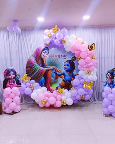 balloon decorations and balloons are displayed in front of a backdrop with images of hindu deities