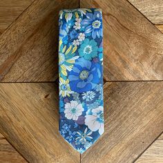 Our Seth Tie displays a mesmerizing blend of blue, yellow, white, and green floral patterns. A great tie for a summer night or a spring afternoon! Details: ➢ 100% Cotton ➢ 60.25” x 2.25” Yellow Summer Ties, Summer Floral Print Ties, Summer Formal Ties With Floral Print, Multicolor Standard Tie For Summer, Blue Spring Tie, Blue Summer Tie, Spring Floral Print Tie, Summer Floral Print Tie, Summer Floral Print Standard Tie