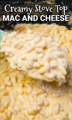 macaroni and cheese being stirred with a wooden spoon