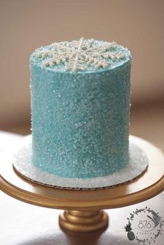 a blue cake sitting on top of a gold plate