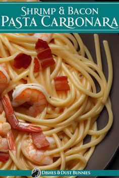 shrimp and bacon pasta carbonara on a black plate with text overlay that reads shrimp & bacon pasta carbonata