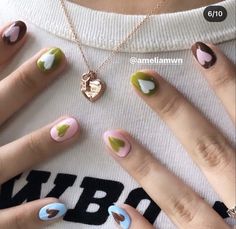 the woman is holding her hands with different designs on their fingers and nail polishes