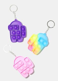 two plastic key chains with legos on them, one is purple and the other is pink