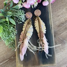 Unveil Your Unique Style! 🌟 Discover the perfect blend of elegance and boldness with our Extra Long Pink and Gold Layered Leather Feather Statement Earrings. Crafted from high-quality, snake-pattern embossed leather, these earrings feature layered feathers in stunning pink and gold tones. The antique gold chain, brown leather cords, and real pink feathers add a touch of bohemian flair, making these earrings a true statement piece. Perfect for Any Occasion 🌼 Day or Night: These earrings are ver Boho Feather Earrings, Feather Resin Earring, Pink Feather Earrings, Long Feather Earrings Boho, Bohemian Black Feather Earrings, Large Statement Earrings, Snake Patterns, Pink Feathers, Bohemian Earrings