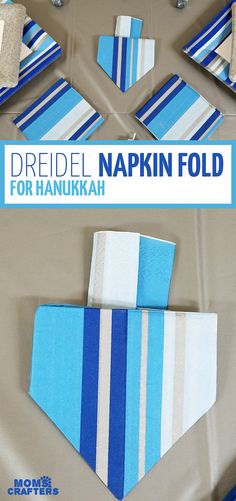 folded napkins with blue and white stripes are arranged on top of a table cloth