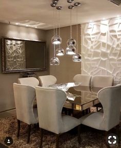 a dining room table with white chairs and chandelier