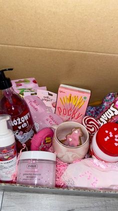 a box filled with lots of different types of beauty and personal care products on top of a wooden table