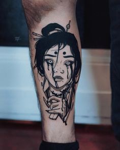 a man's leg with a tattoo on it that has an image of a woman