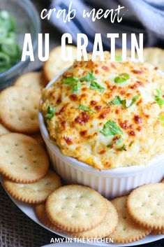 a bowl of cheese dip surrounded by crackers