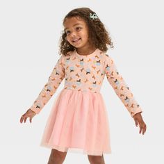 Your little one will love the magical charm of this Afro Unicorn Tulle Dress. This pullover dress features a long-sleeve jersey bodice in light pink with colorful Afro Unicorn graphics, stars and hearts. A flouncy knee-length mesh skirt in pretty pink completes the look with ballerina-worthy flair. April Showers is founder and CEO of Afro Unicorn, a brand designed to remind women and children of color how unique, divine and magical they truly are. Her goal from the beginning was to help normaliz Spring Party Tutu Dress With Long Sleeves, Pink Long Sleeve Tutu Dress For Spring, Spring Party Long Sleeve Tutu Dress, Spring Long Sleeve Pink Tutu Dress, Pink Princess Long Sleeve Tutu Dress, Pink Long Sleeve Princess Tutu Dress, Playful Long Sleeve Dresses For Fall, Long Sleeve Tutu Dress For Party, Playful Multicolor Long Sleeve Dress