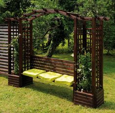 a wooden bench sitting in the middle of a lush green park