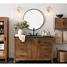 a bathroom with wooden cabinets and a round mirror above the sink, along with baskets on the floor