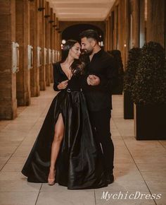 a man and woman in formal wear standing next to each other on a tiled floor