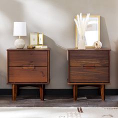 two wooden nightstands sitting next to each other on top of a carpeted floor