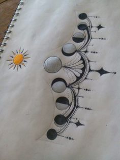 an artistic drawing on paper with the sun and moon in it's center surrounded by black dots