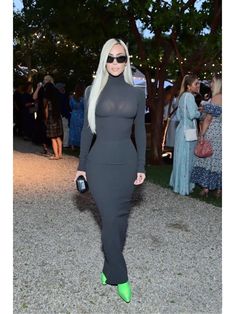 lady in black dress and green heels at an event