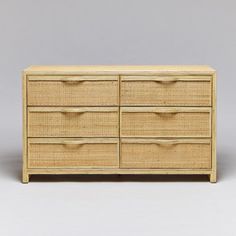 a wicker dresser with six drawers on one side and two doors on the other