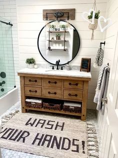 a bathroom with a sink, mirror and rug