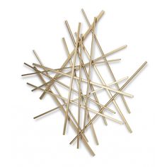 a pile of wooden sticks sitting on top of a white floor next to each other