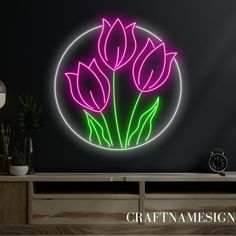 a neon sign with flowers in a circle on the wall next to a dresser and clock