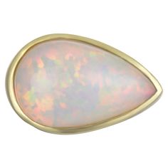 Experience luxury with Faye Kim's 18 Karat Gold Bezel Set Opal Ring. For those lucky enough to be born in October, here is a true one-of-a-kind treasure and the perfect birthstone ring. Lively color of play with red and green flashes. Architectural design, and perfectly stylish on any finger. Opal: 11 Carats Ring size - 7.75 Made in the USA Pear Shape Opal Ring, Vanilla Gelato, Born In October, Pear Shaped Ring, Ethiopian Opal Ring, Vintage Style Rings, Contemporary Ring, Jade Ring, Domed Ring