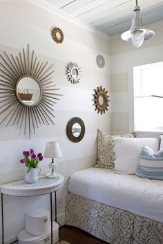 an image of a small bedroom with white walls and decor on the bottom right corner