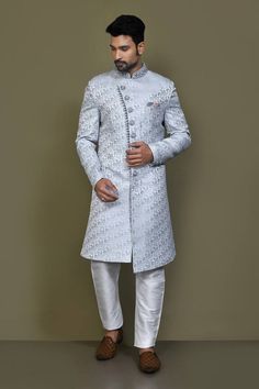 Light grey full sleeves asymmetric hem and placket sherwani crafted in imported jacquard silk with all over flowery pattern and hand embroidery on the band collar neckline and buttons. Paired with an off white dupion art silk Aligadhi pant. - Aza Fashions Grey Sherwani, Self Design, Band Collar, Full Sleeves, Pocket Square, Asymmetric Hem, Aza Fashion, Full Sleeve, Hand Embroidery