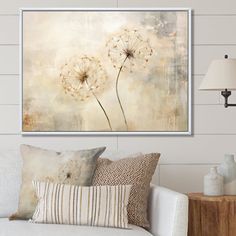 a living room scene with focus on the dandelion wall art above the couch