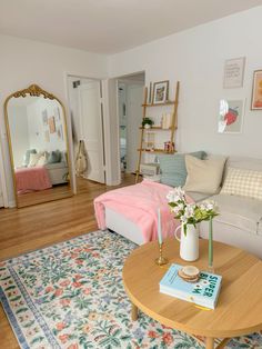 a living room filled with furniture and a large mirror