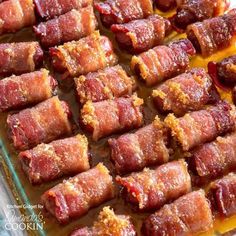 bacon wrapped in small pieces on a baking sheet ready to go into the oven for cooking