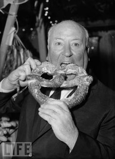 an old man is eating a giant donut