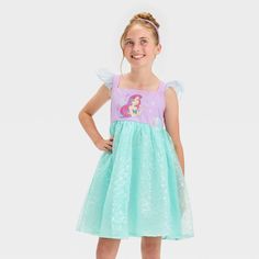 Dress up your kid in their favorite princess-inspired look with the Disney Princess Ariel Puff-Cap-Sleeve Dress. Made in mint green and purple hues, this cap-sleeve dress features a print of Ariel at the front and scale-like, silver detailing on the skirt. Tailored from soft and lightweight fabric, this knee-length dress helps keep them throughout the day. Mint Green And Purple, Purple L, Disney Princess Ariel, Princess Inspired, Princess Ariel, Cap Sleeve Dress, Princess Girl, Kids Outfits Girls, Capped Sleeve Dress