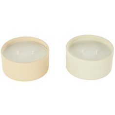 two white candles sitting next to each other