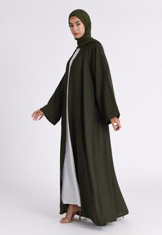 Our simple and elegant plain emerald green open abaya is perfect for everyday wear. A perfect essential piece for every wardrobe. Style it with our Inner slips (sold separately). The abaya features pop up buttons on the front of the abaya and the inner sleeves allowing you to style the abaya at your comfort. Made with the high grade Nida material. Includes matching belt and chiffon hijab to complete the modest look. This Classic Emerald Green Open abaya can be worn on any occasion. Ready to Dispatch Made with high grade Nida fabric Matching Hijab & belt included Ideal for Ramadan / daily wear Modest Green Abaya For Eid, Green Long Thobe For Eid, Modest Green Maxi Length Abaya, Modest Long Green Abaya, Muslim Long Dress, Women Abaya, Arabic Dress, Green Kimono, Fabric Matching