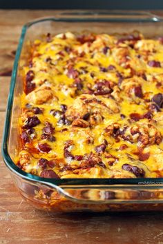 a casserole dish with meat and cheese in it on a wooden table top