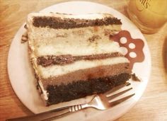 a piece of cake sitting on top of a white plate next to a knife and fork