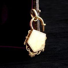 The fanciest padlock we've ever seen was made in buttery 18k gold in France, sometime around the year 1880. Pearls and diamonds decorate it. Extraordinary craftsmanship. MATERIALS: 18k gold (marked), 4.8mm pearl and 6 seed pearls, 12 rose cut diamonds AGE: c. 1880 CONDITION: Very good - minor surface wear commensurate with age and use SIZE: 2" total length including the bale, 1 1/8" width Vintage Gold Lock Jewelry, Vintage Gold Jewelry With Lock, Formal Gold Jewelry With Lock, Seed Pearl, Rose Cut Diamond, Rose Cut, Diamond Cuts, The Year, 18k Gold