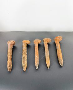 five ancient tools are lined up on a table